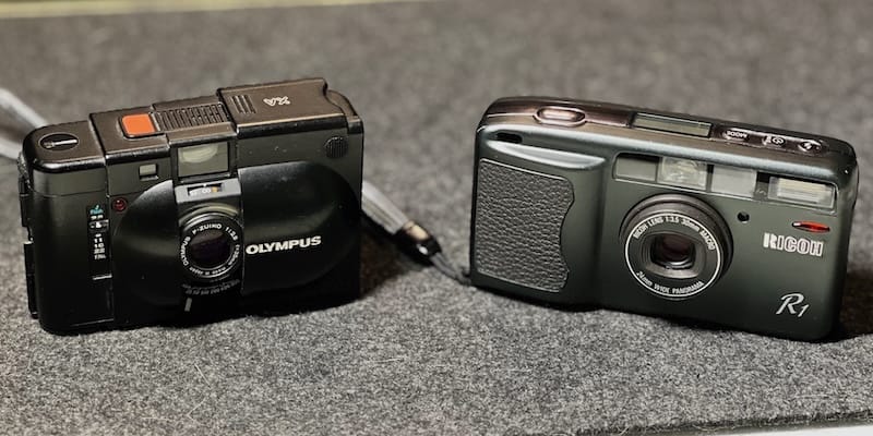 The Ricoh R1 compared to the size of the Olympus XA