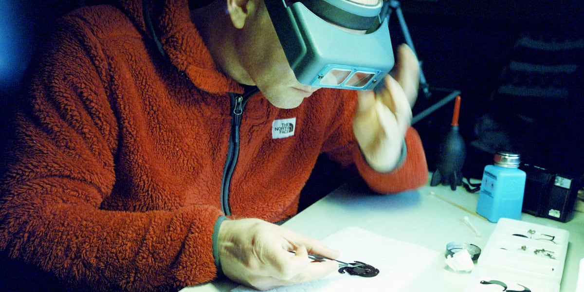 Carefully reassembling the aperture blades