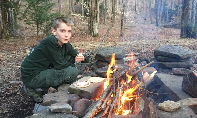 Cooking pizza dough on a hot rock