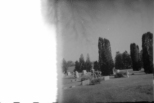 A man tending to a grave marker